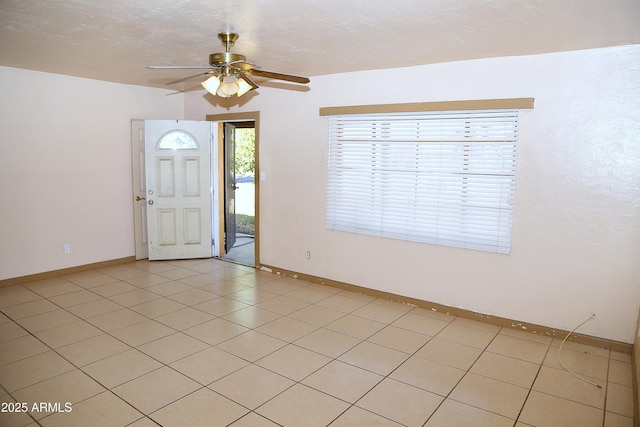 entryway featuring a ceiling fan and baseboards