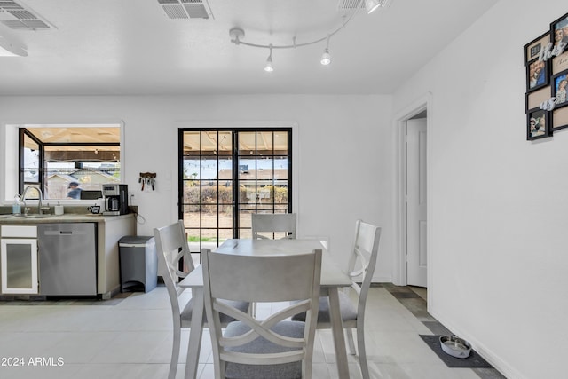 dining space with sink and light tile patterned floors