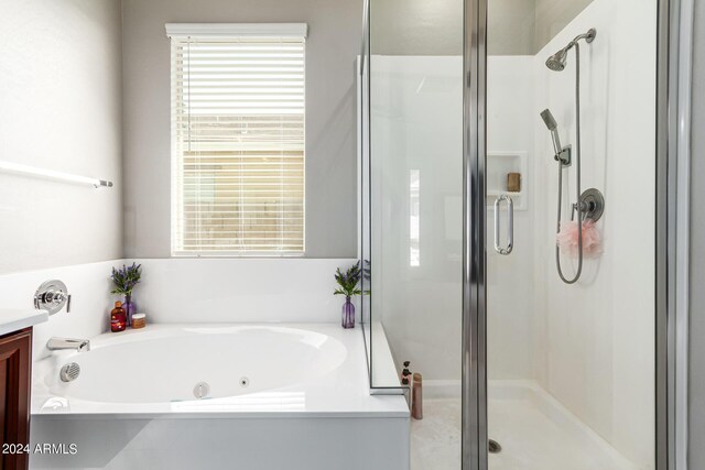 bathroom featuring independent shower and bath and vanity