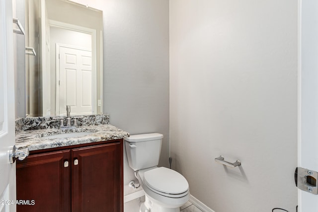 bathroom featuring tile patterned flooring, vanity, and toilet