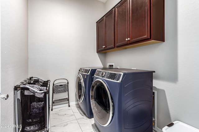 laundry area featuring independent washer and dryer and cabinets