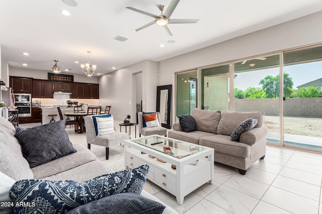 living room with ceiling fan with notable chandelier