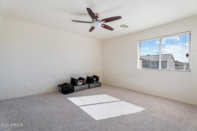 empty room with ceiling fan and carpet