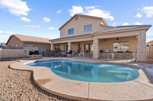 view of swimming pool with ceiling fan and a patio