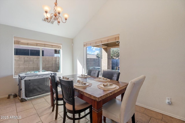 dining room with lofted ceiling, a chandelier, and light tile patterned flooring