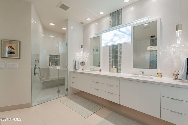 bathroom featuring tile patterned flooring, vanity, and an enclosed shower