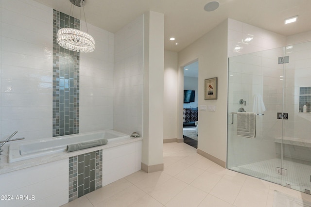 bathroom with tile patterned floors, independent shower and bath, and a chandelier