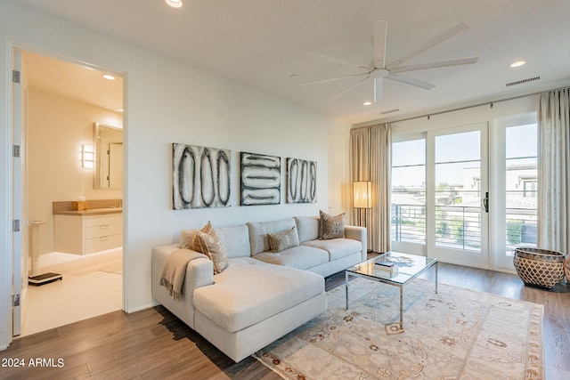 living room featuring ceiling fan and hardwood / wood-style floors