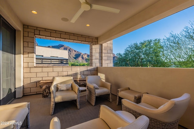 view of patio / terrace featuring a mountain view, ceiling fan, and an outdoor living space