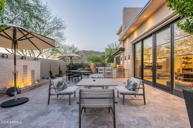 view of patio / terrace featuring a mountain view, an outdoor living space, and area for grilling