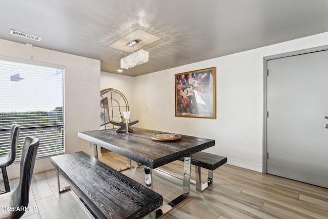 dining space with light wood-type flooring and a wealth of natural light