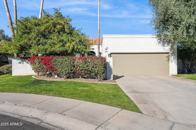 view of front of house with a front lawn and a garage