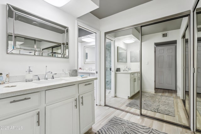 bathroom with vanity and hardwood / wood-style flooring