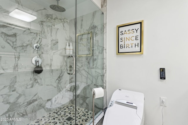 bathroom featuring washer / dryer and an enclosed shower