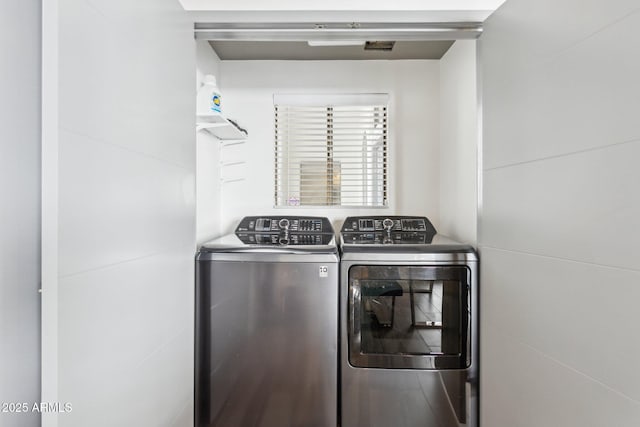 clothes washing area featuring washing machine and dryer