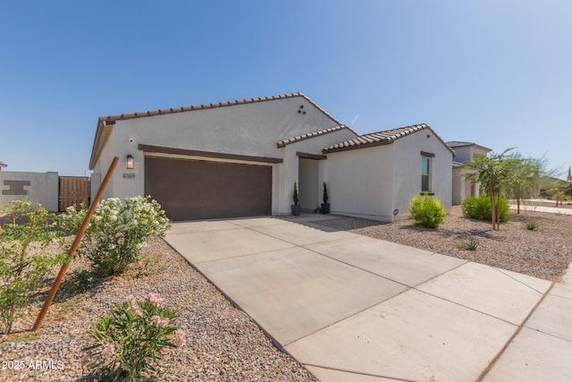 47469 W Cansados Rd, Maricopa, AZ 85139 - mediterranean / spanish-style home featuring a garage, driveway, stucco siding, and a tile roof