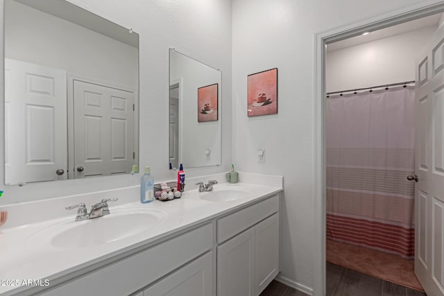 47469 W Cansados Rd, Maricopa, AZ 85139 - full bathroom featuring double vanity, wood finished floors, and a shower with curtain