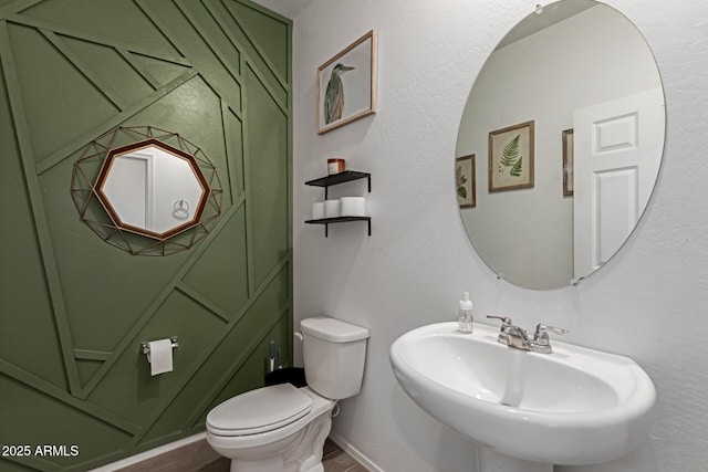 47469 W Cansados Rd, Maricopa, AZ 85139 - half bath featuring a sink and wood finished floors