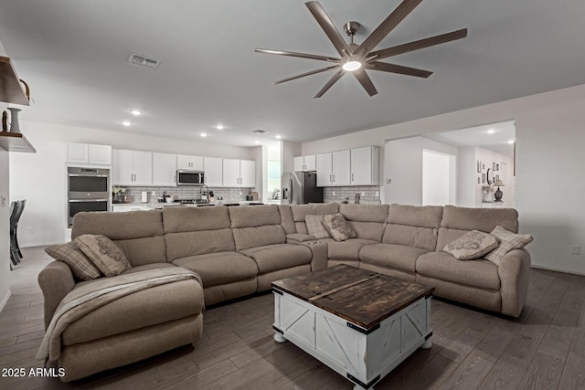 47469 W Cansados Rd, Maricopa, AZ 85139 - living room featuring dark wood-style flooring, ceiling fan, and recessed lighting