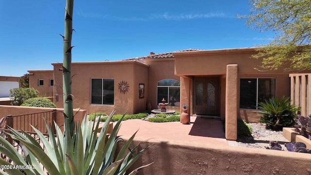 view of front of property with french doors and stucco siding
