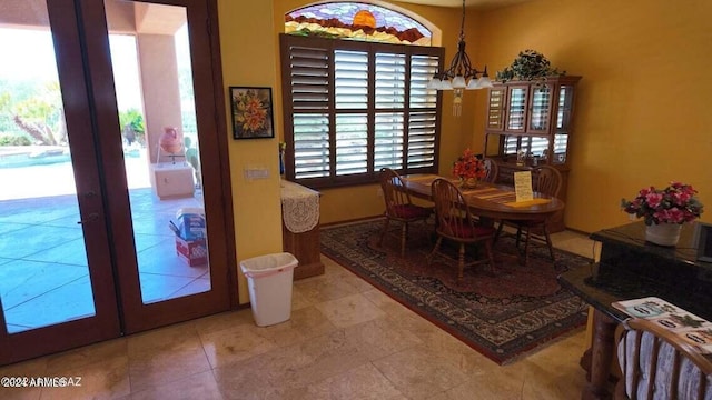 dining space with a notable chandelier and french doors