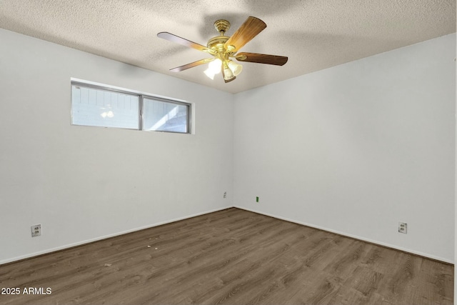 unfurnished room featuring ceiling fan, a textured ceiling, baseboards, and wood finished floors