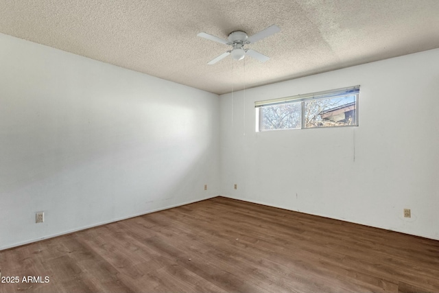 spare room featuring a ceiling fan, a textured ceiling, and wood finished floors