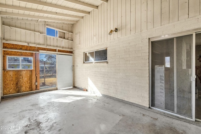 interior space with high vaulted ceiling, concrete floors, and beam ceiling