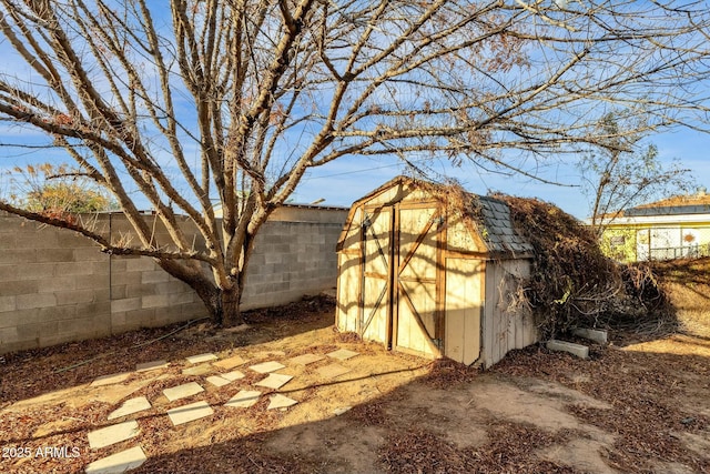 view of shed featuring a fenced backyard