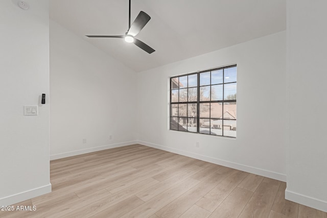 spare room featuring lofted ceiling, ceiling fan, and light wood-type flooring