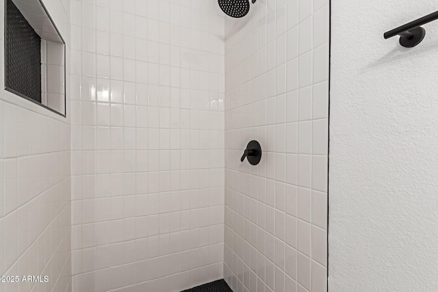 bathroom with tiled shower