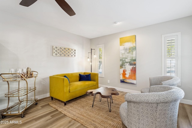 sitting room featuring wood-type flooring and ceiling fan