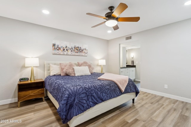 bedroom with connected bathroom, ceiling fan, and hardwood / wood-style floors