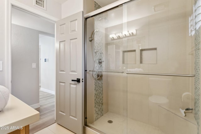 bathroom with vanity and a shower with shower door