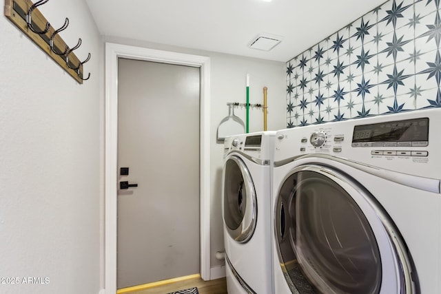 laundry area featuring hardwood / wood-style floors and washer and dryer