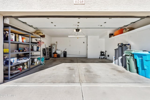 garage featuring electric water heater and a garage door opener