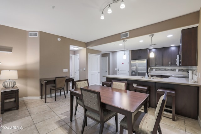 tiled dining room with sink