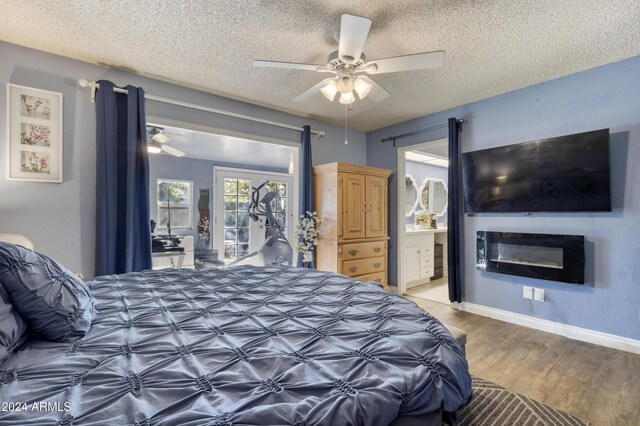 bedroom featuring ceiling fan, ensuite bathroom, a textured ceiling, and wood-type flooring