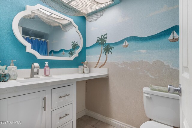 bathroom featuring tile patterned flooring, vanity, and toilet