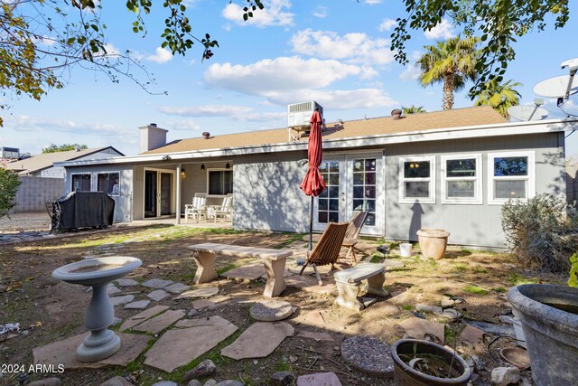 rear view of house with a patio area and french doors