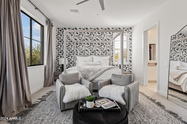 bedroom featuring carpet floors, ensuite bath, and ceiling fan