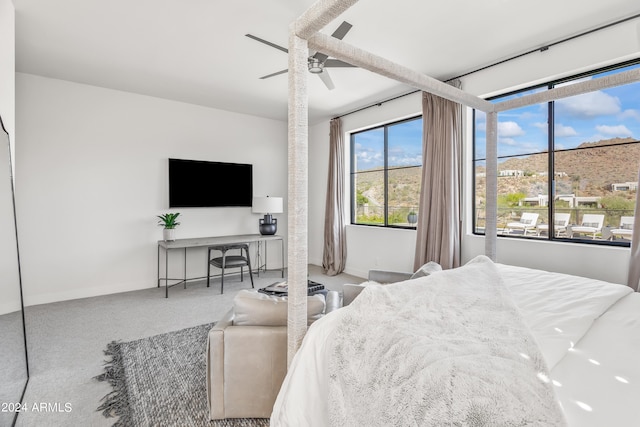 bedroom featuring ceiling fan and carpet