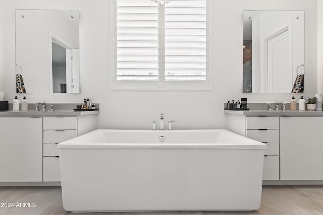 bathroom with vanity and a tub to relax in