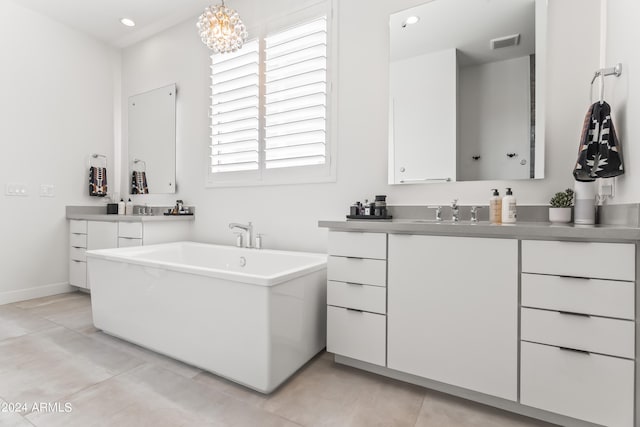 bathroom featuring vanity, an inviting chandelier, and a bath