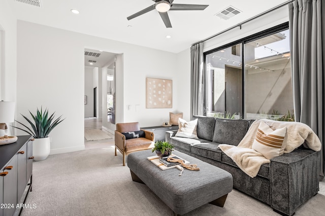 living room featuring light carpet and ceiling fan