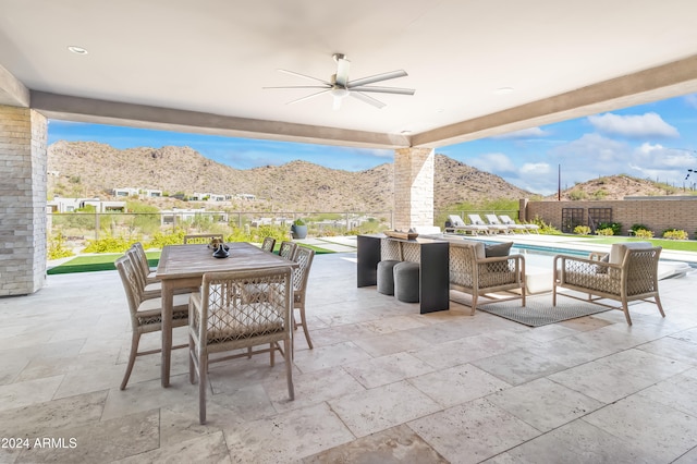 view of patio featuring a mountain view and ceiling fan