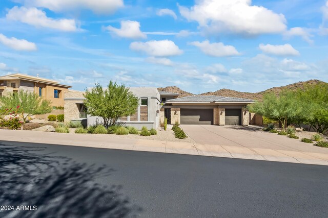 prairie-style house with a garage and a mountain view