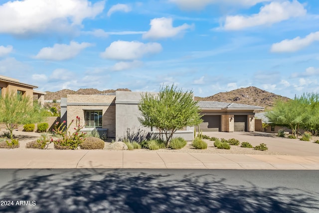 view of front of house featuring a garage and a mountain view