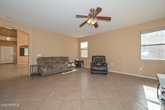 16112 W Durango St, Goodyear, AZ 85338 - living room with baseboards, arched walkways, ceiling fan, and light tile patterned floors