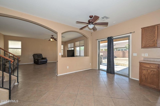 16112 W Durango St, Goodyear, AZ 85338 - interior space featuring visible vents, stairs, ceiling fan, arched walkways, and light tile patterned floors